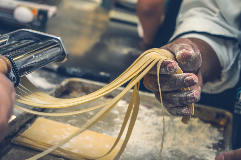 A chef’s flour-dusted hands carefully handle freshly made pasta strands, just rolled through a stainless steel pasta machine. The rustic, hands-on approach highlights the artistry and craftsmanship found in St. Barts' gourmet kitchens, where fresh, high-quality ingredients and expert techniques come together to create world-class culinary experiences.