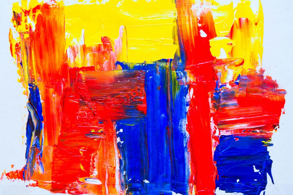 A vibrant abstract painting with bold strokes of red, yellow, and blue, symbolizing the dynamic arts and design scene in St. Barts, where local and international artists showcase creativity through contemporary and Caribbean-inspired artwork.